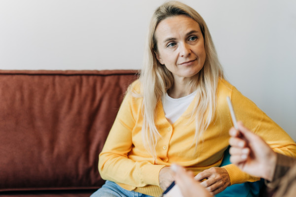 A woman discussing treatment options with her hearing professional